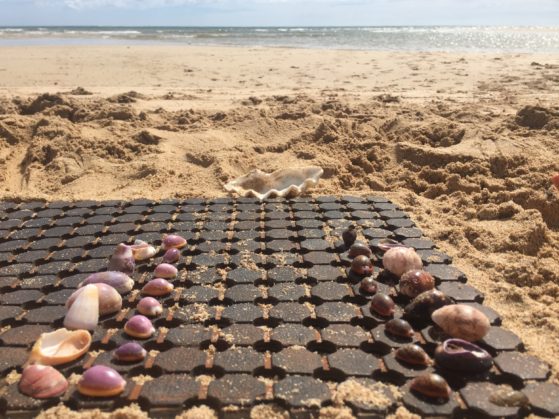 Holiday activities: Beach chess made from shells and a bath mat