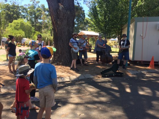 Kale watching musicians busk at Nannup music festival