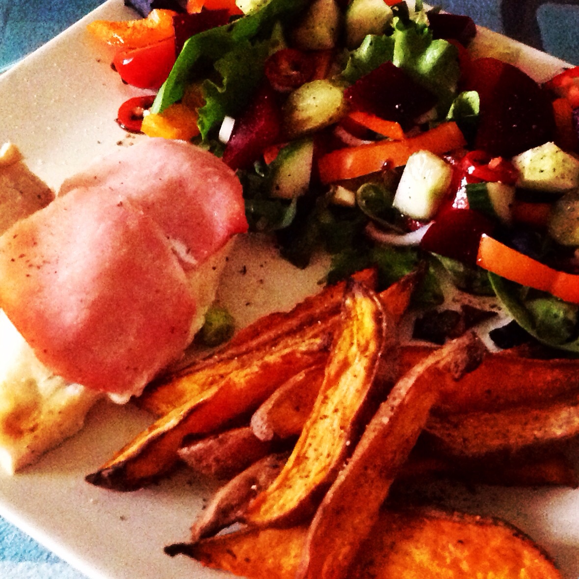 Chicken stuffed with quark and garlic wrapped in bacon, sweet potato chips and salad