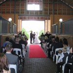Wedding Ceremony with red carpet in barn at Brookleigh Estate