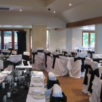 Wedding Reception with white chairs and black ribbons at Brookleigh Estate