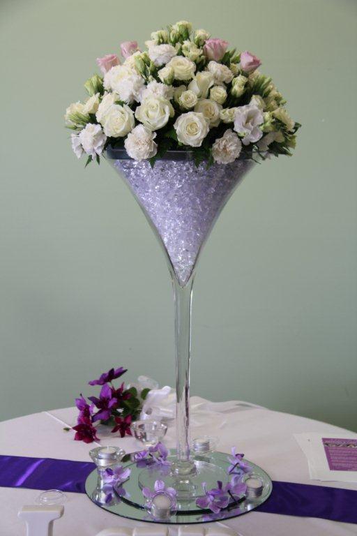 Centerpiece of white and pink flowers in tall glass for a wedding