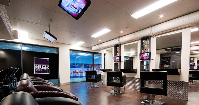 Hair studio at guys grooming with chairs and tvs