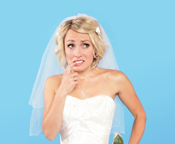 Blue background with bride in white looking concerned and scared