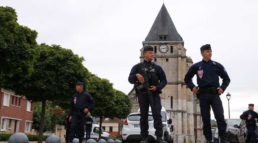 Security guards outside the church in Rouen where Fr Hamel was slain