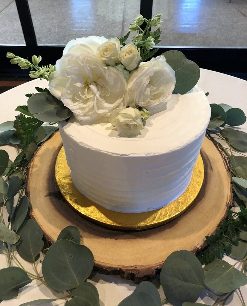 Wedding cake with roses and larkspur