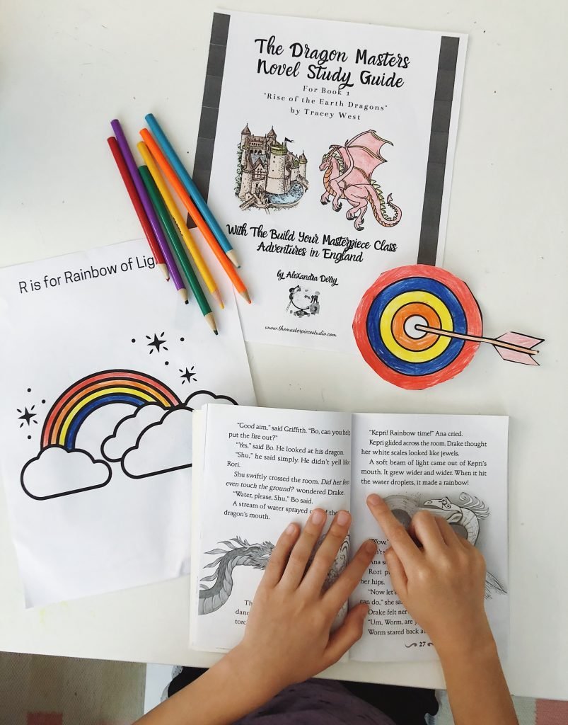 Child reading the Dragon Masters Book with the Dragon Masters Study Guide along with coloring pages and colored pencils.