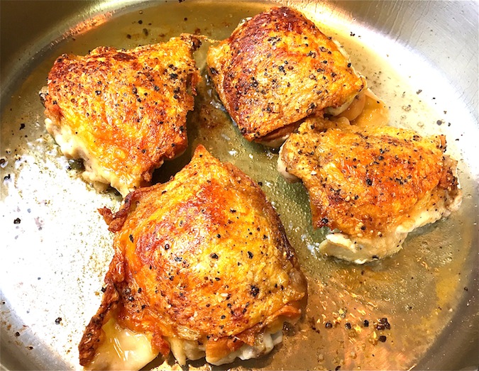 perfect-pairings-crispy-chicken-thighs-cooking-in-pan