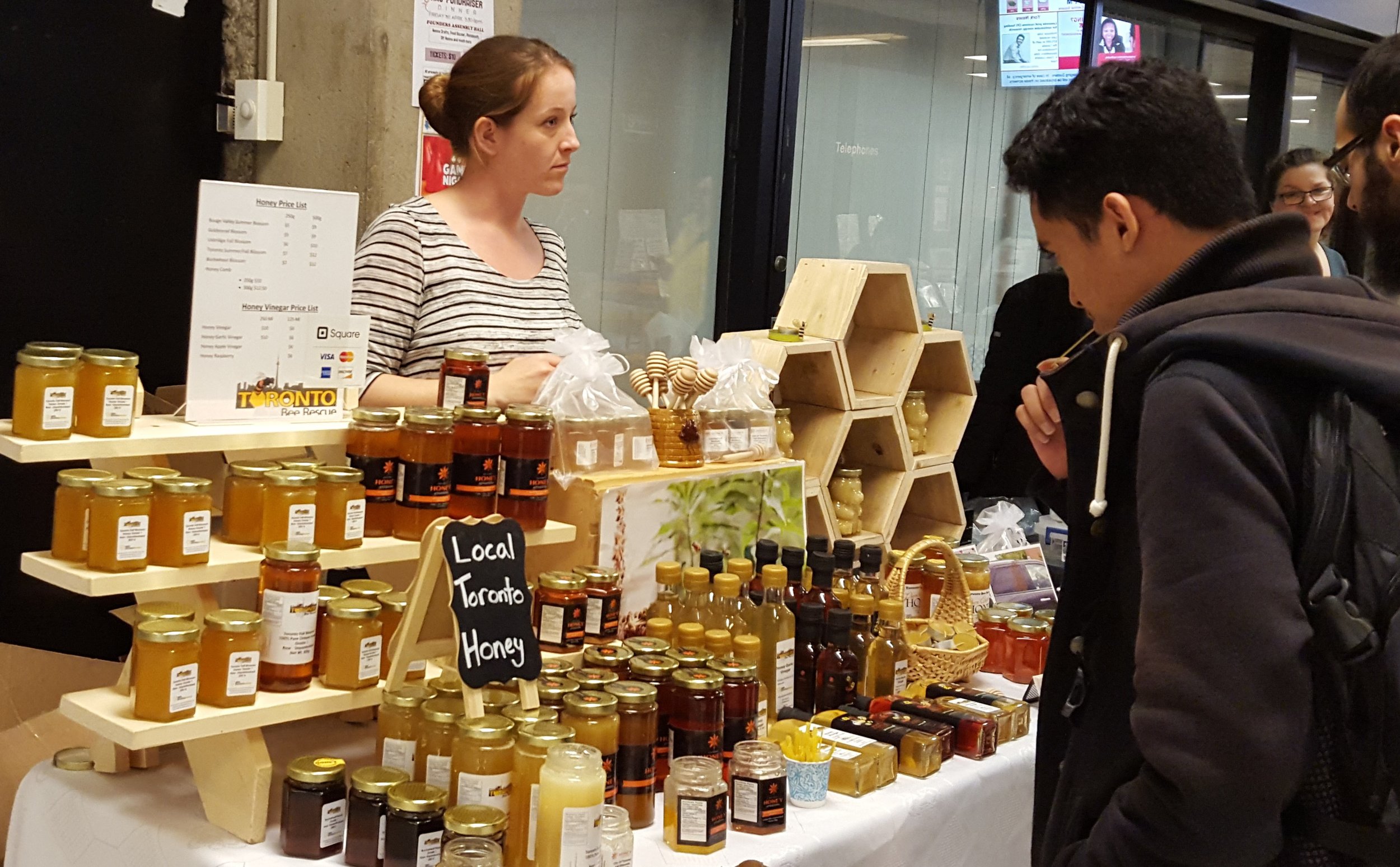 A student mulls over this selection of honey 