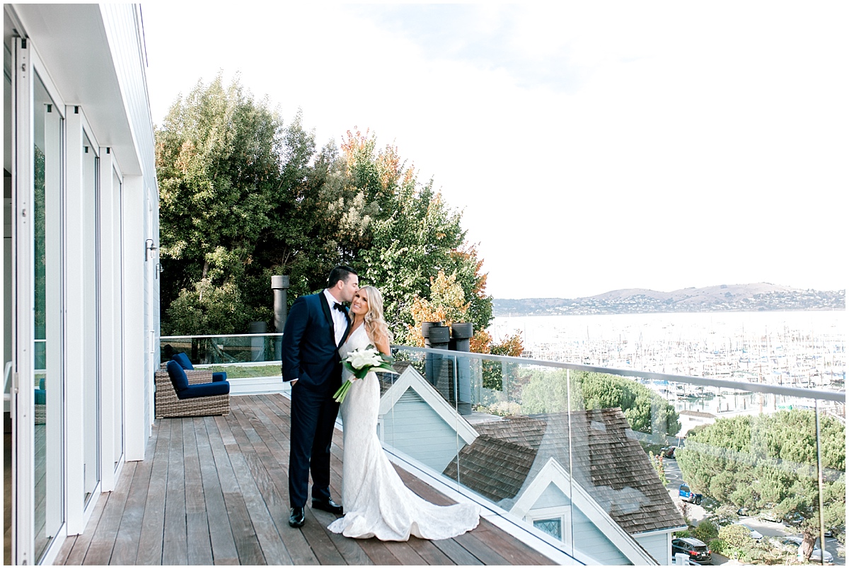Gorgeous wedding at Presidio Yacht Club bride and groom posing on upper deck overlooking Sausalito Marina at Casa Madrona