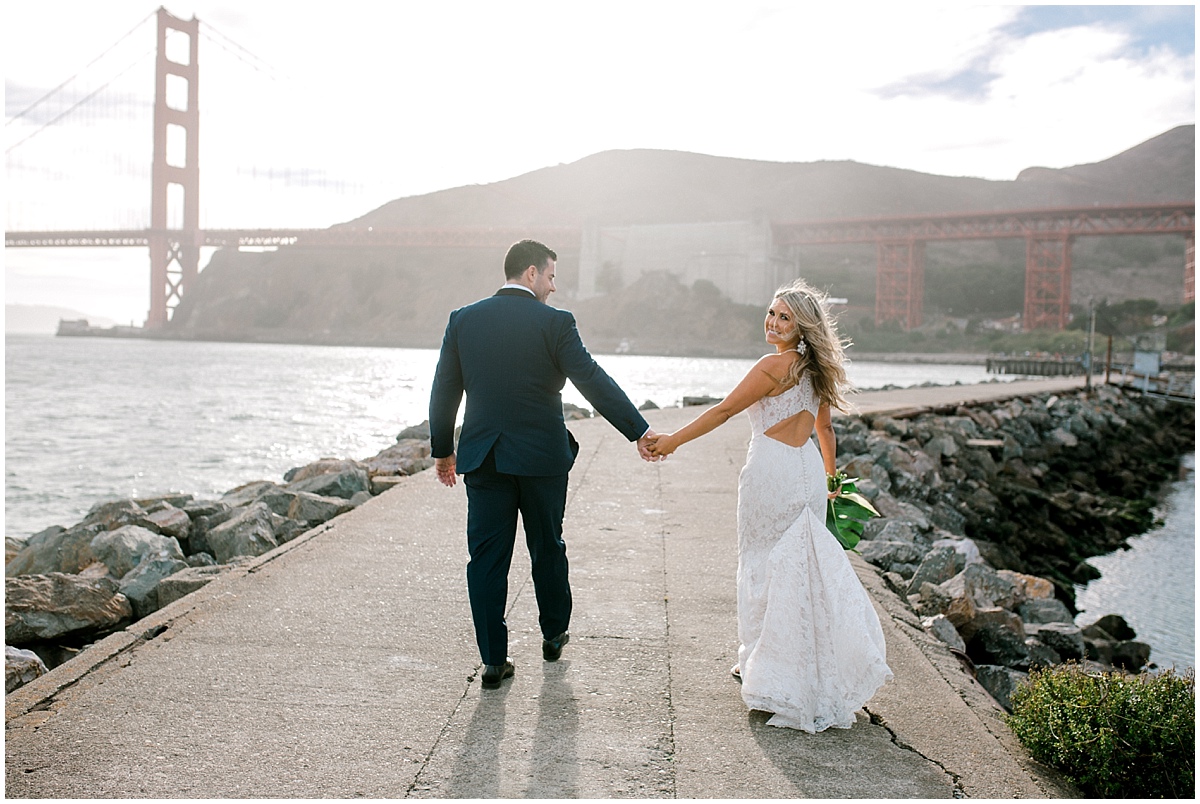 Gorgeous wedding at Presidio Yacht Club bride looking back as wind blows