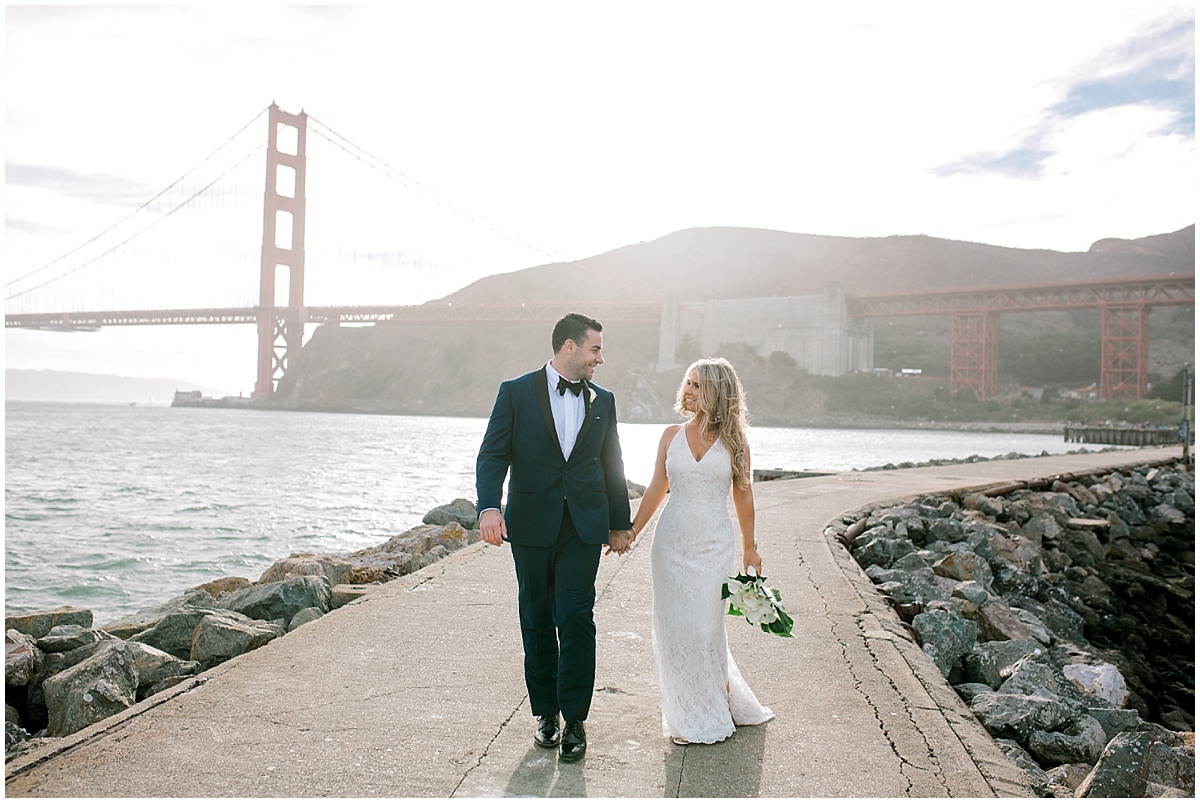 Gorgeous wedding at Presidio Yacht Club bride and groom holding hands and walking