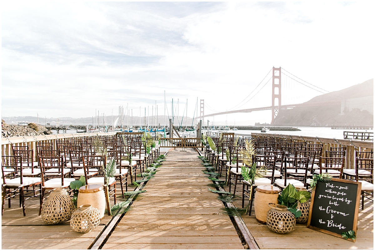 Gorgeous wedding at Presidio Yacht Club wide ceremony shot with golden gate bridge in the background