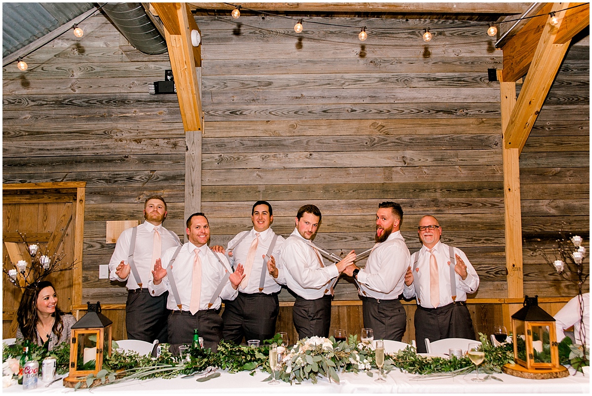 Wedding at Rustic Grace Estate groomsmen being silly with their suspenders