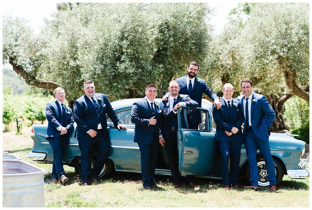 Wedding-at-Rus-Farm-groomsmen-with-vintage-car