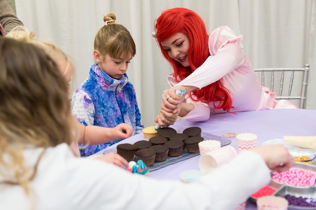 Ariel helps decorate cupcakes a kid's birthday party in Calgary