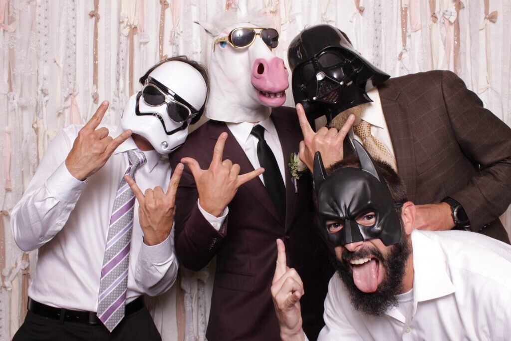 guests wearing different photo booth props at a wedding