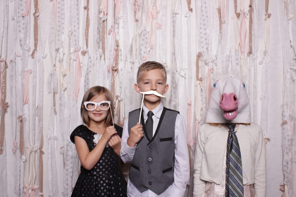 kids enjoying a photo booth at a wedding reception