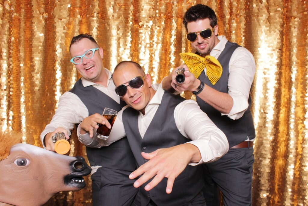 groomsmen looking handsome in a wedding photo booth