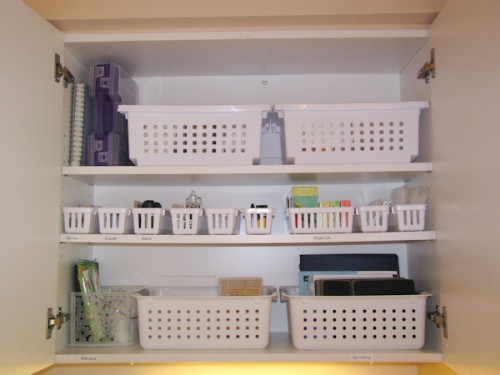 scrapbook supplies in kitchen cupboard