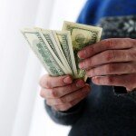 Closeup portrait of a male hands holding US dollars