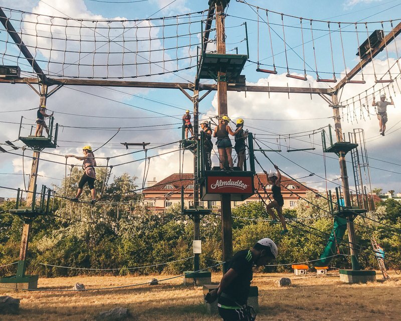 Outdoor ropes course with people climbing