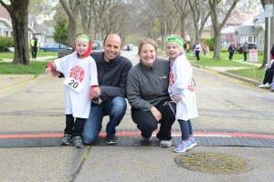 Dave and Dana Wurzburger pose with their 4-year-old twins, Isaac and Abby, after the Run Tosa Run kids' run. Photo by Mindy Mays.