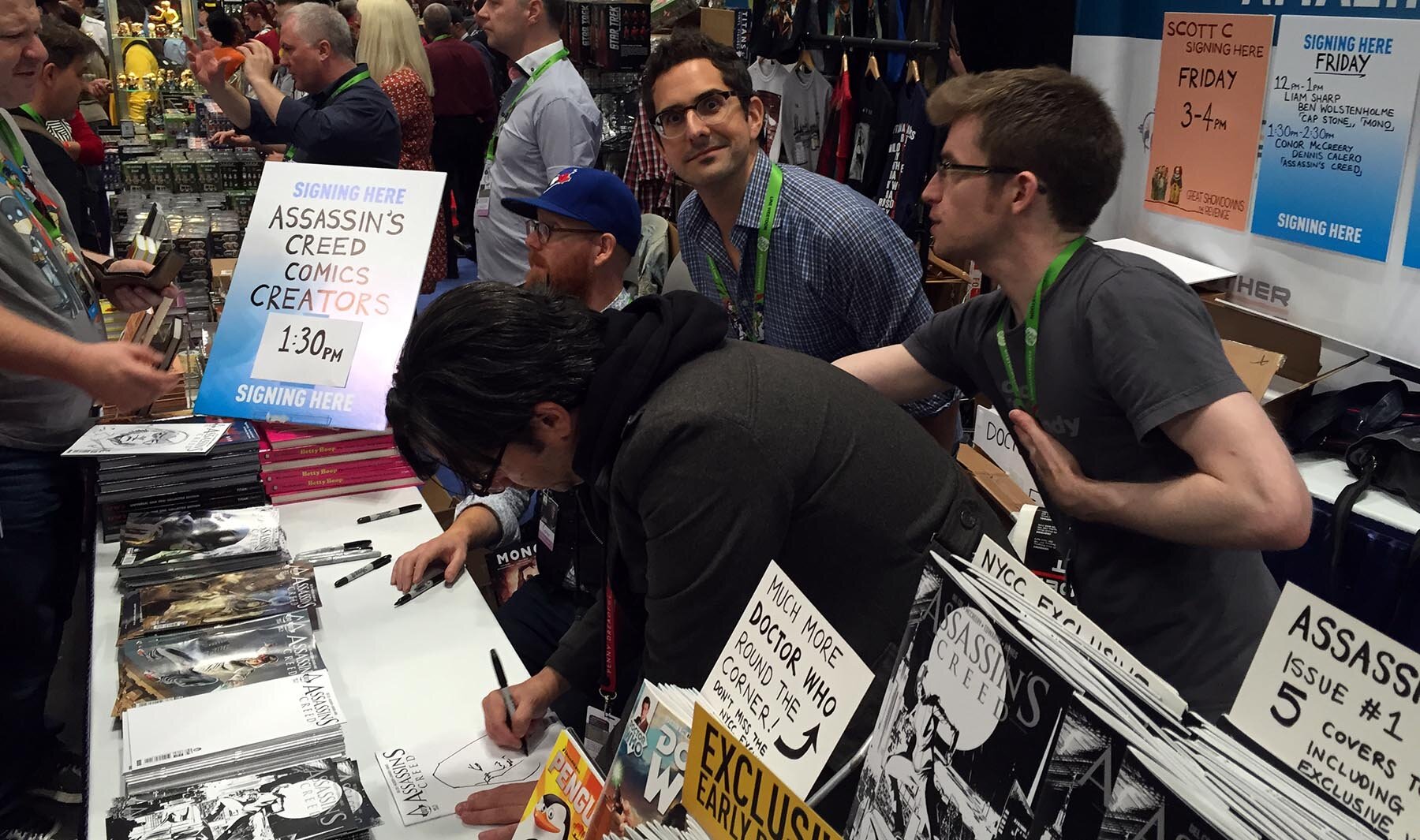 Yes, me signing at the Titan Comics booth at NYCC 2015. Conor, editor Andrew James and artist Dennis Calero are actually doing work while I pose.