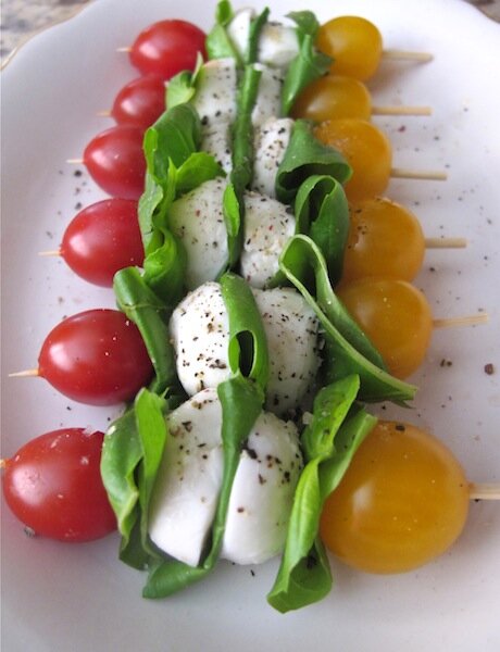Delicious tomato, mozzarella & basil skewers. So easy to make & delicious. Drizzle with olive oil, sprinkle with salt & pepper & serve.