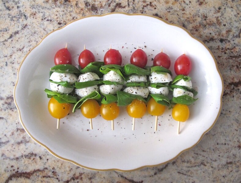 Delicious tomato, mozzarella & basil skewers. So easy to make & delicious. Drizzle with olive oil, sprinkle with salt & pepper & serve.