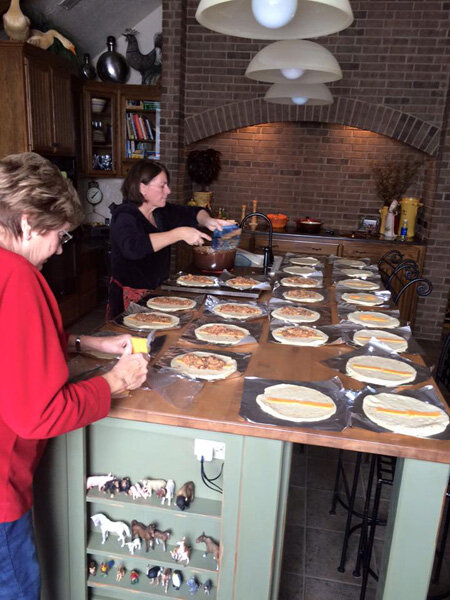 Cheri Hanson and her mother, Gert Van Dam, making burritos for the employees during the blizzard.