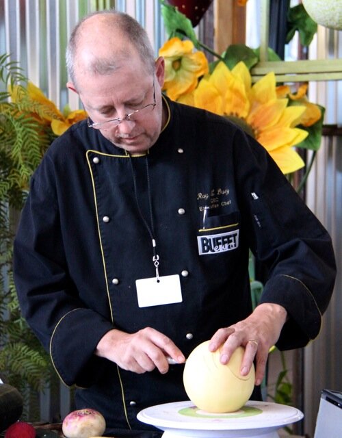 Chef Ray L. Duey, carving a melon