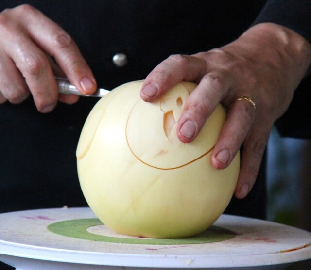 Chef Ray L. Duey, carving a melon 