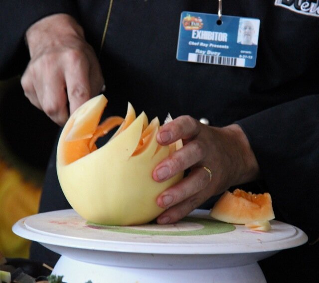 Chef Ray L. Duey, removing excess melon parts