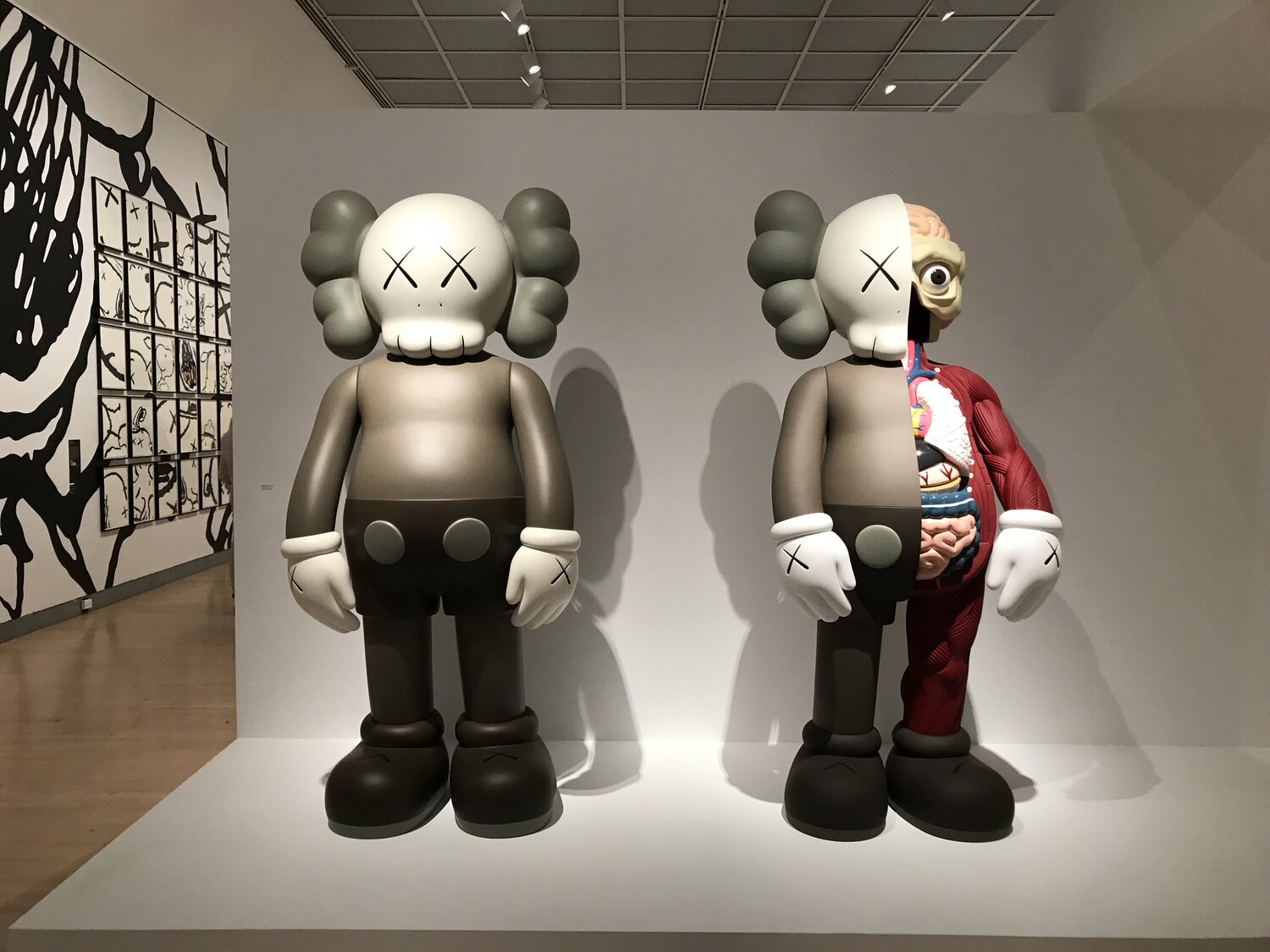 Premium AI Image  Kaws Unleashed The Iconic Artist Bedecked in Tattoos  Musing on a Louis Vuitton Throne