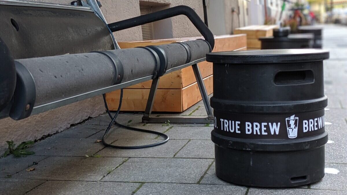 A picture of a beer table made out of a keg at True Brew on the pavement outside the bar in Munich
