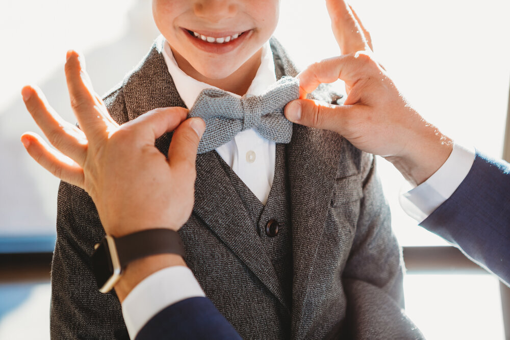  A smile and bow tie from the ring bearer could not have been cuter as the groom adjusts his tie #tealawardphotography #texasweddings #amarillophotographer #amarilloweddingphotographer #emotionalphotography #intimateweddingphotography #weddingday #weddingphotos #texasphotographer #inspiredwedding #intimatewedding #weddingformals #bigday #portraits 