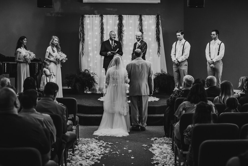  Black and white wedding ceremony photo of the bride and groom saying their vows #tealawardphotography #texasweddings #amarillophotographer #amarilloweddingphotographer #emotionalphotography #intimateweddingphotography #weddingday #weddingphotos #texasphotographer #inspiredwedding #intimatewedding #weddingformals #bigday #portraits 