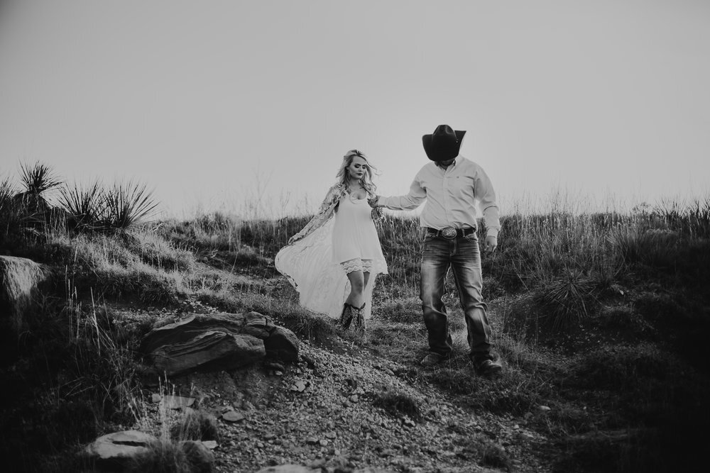  Groom to be leads his fiance down a path with photo in black and white #engagementphotos #engaged #personality #amarillotexas #engagementphotographer #lifestylephotos #amarillophotographer #locationchoice #texasengagementphotos #engagment #tealawardphotography #westernstyle 