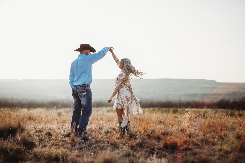  He spins her round and round on top of the world during engagement photo session #engagementphotos #engaged #personality #amarillotexas #engagementphotographer #lifestylephotos #amarillophotographer #locationchoice #texasengagementphotos #engagment #tealawardphotography #westernstyle 
