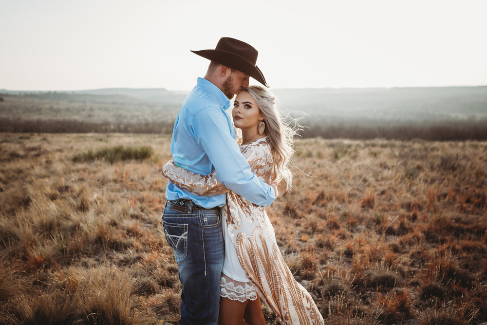  Profile of bride to be and groom to be kissing her on the forehead in the sun set #engagementphotos #engaged #personality #amarillotexas #engagementphotographer #lifestylephotos #amarillophotographer #locationchoice #texasengagementphotos #engagment #tealawardphotography #westernstyle 