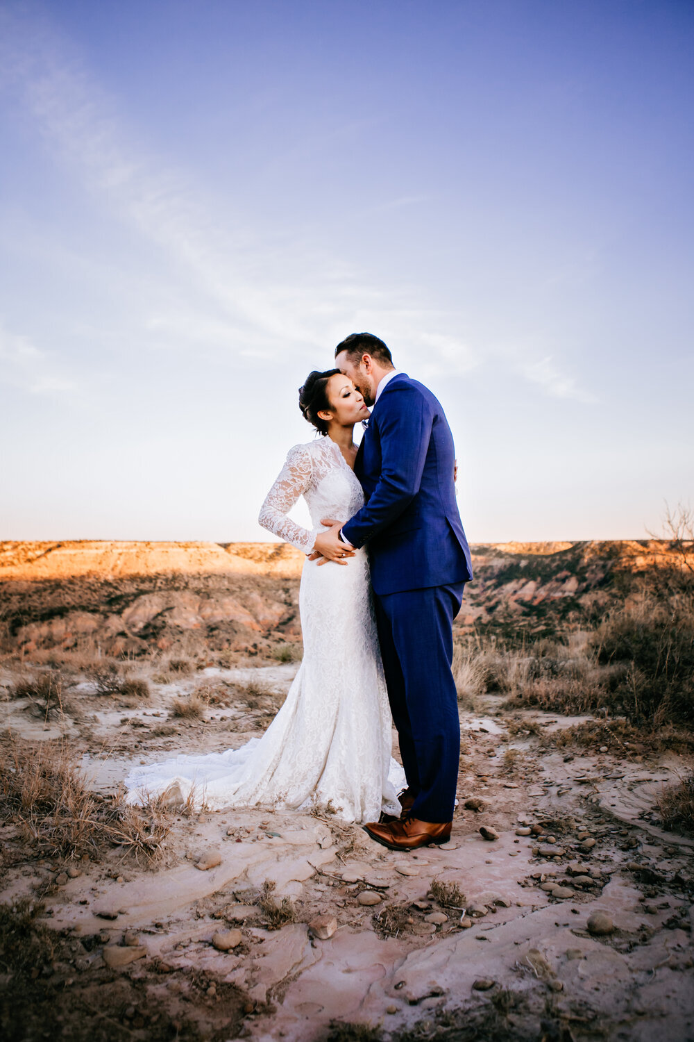  The bride’s gorgeous dress seemed to have lace that extended all the way to the edge fo this photo as the groom kisses her sweetly on the cheek #tealawardphotography #texasweddings #amarillophotographer #amarilloweddingphotographer #emotionalphotography #intimateweddingphotography #weddingday #weddingphotos #texasphotographer #inspiredwedding #intimatewedding #weddingformals #bigday #portraits 