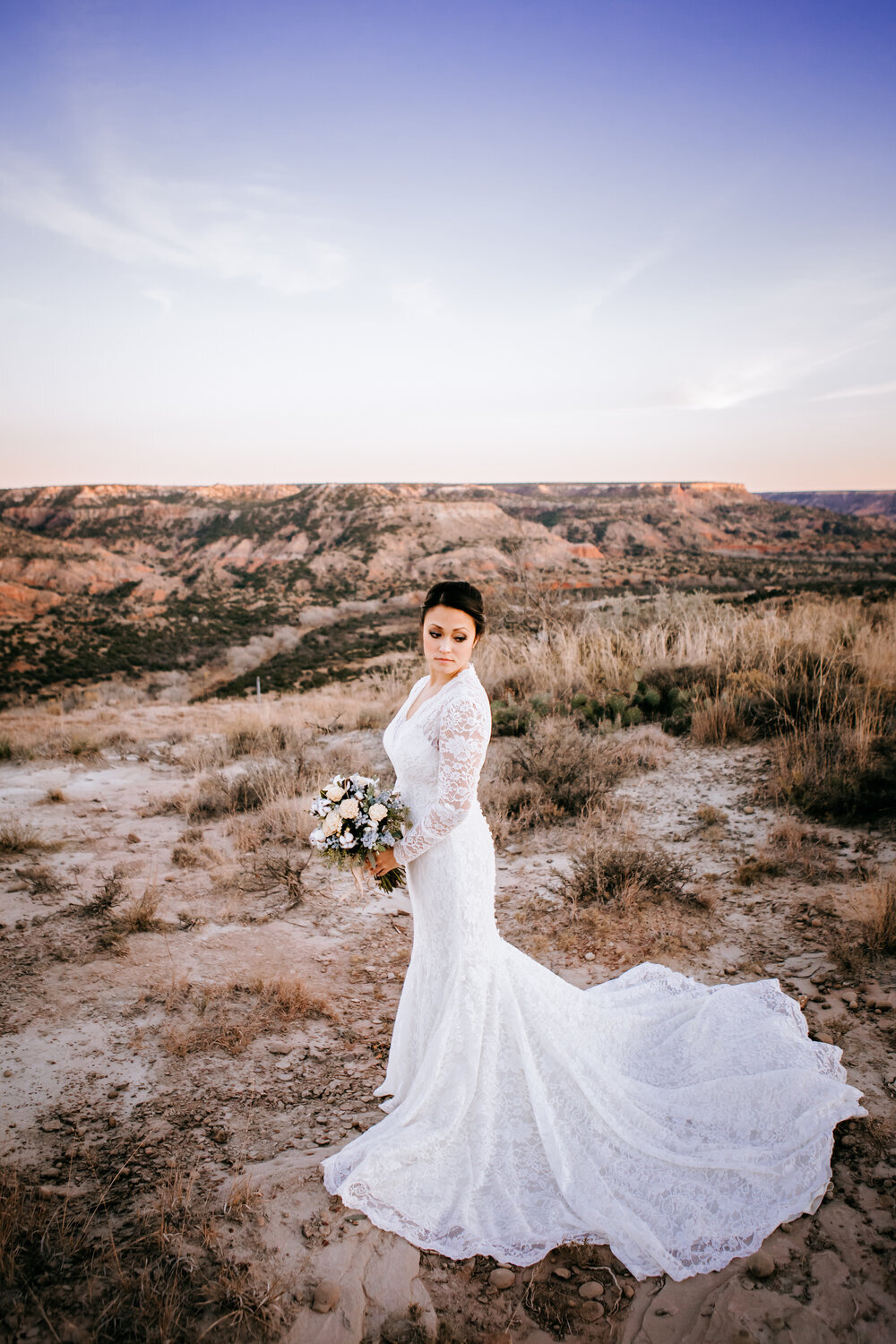  This portrait of the bride is breathtaking against the Palo Duro Canyon backdrop on her wedding day #tealawardphotography #texasweddings #amarillophotographer #amarilloweddingphotographer #emotionalphotography #intimateweddingphotography #weddingday #weddingphotos #texasphotographer #inspiredwedding #intimatewedding #weddingformals #bigday #portraits 