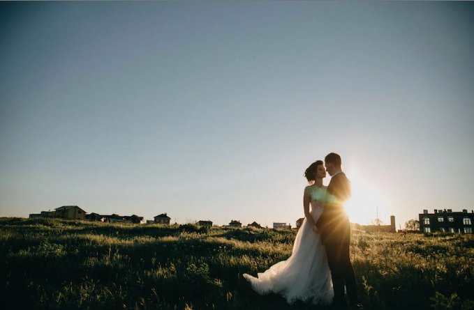newly married couple taking wedding photos on farm