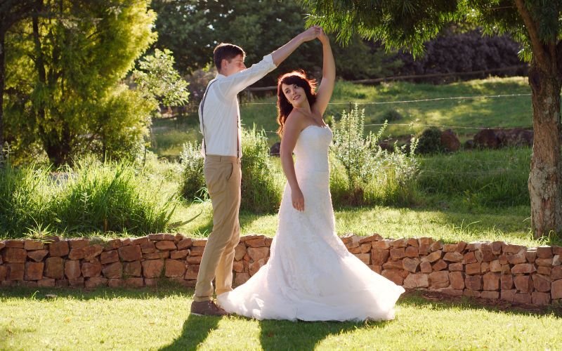 bride and groom dancing in a golf course