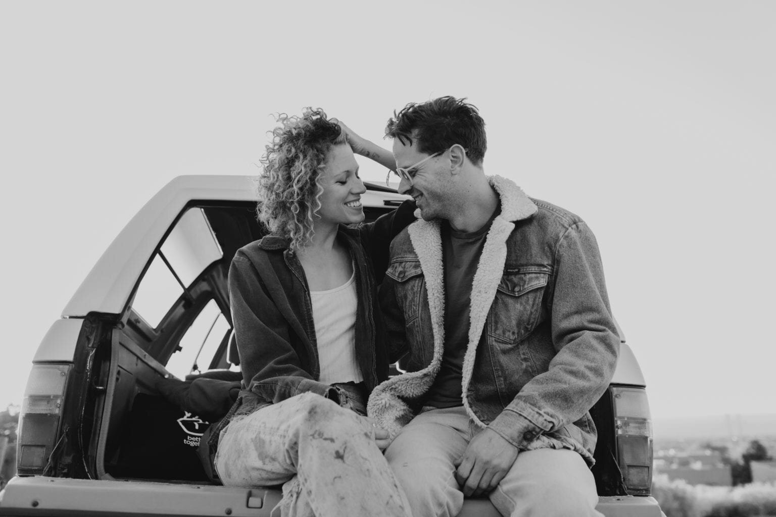 Couple Sitting on back of truck