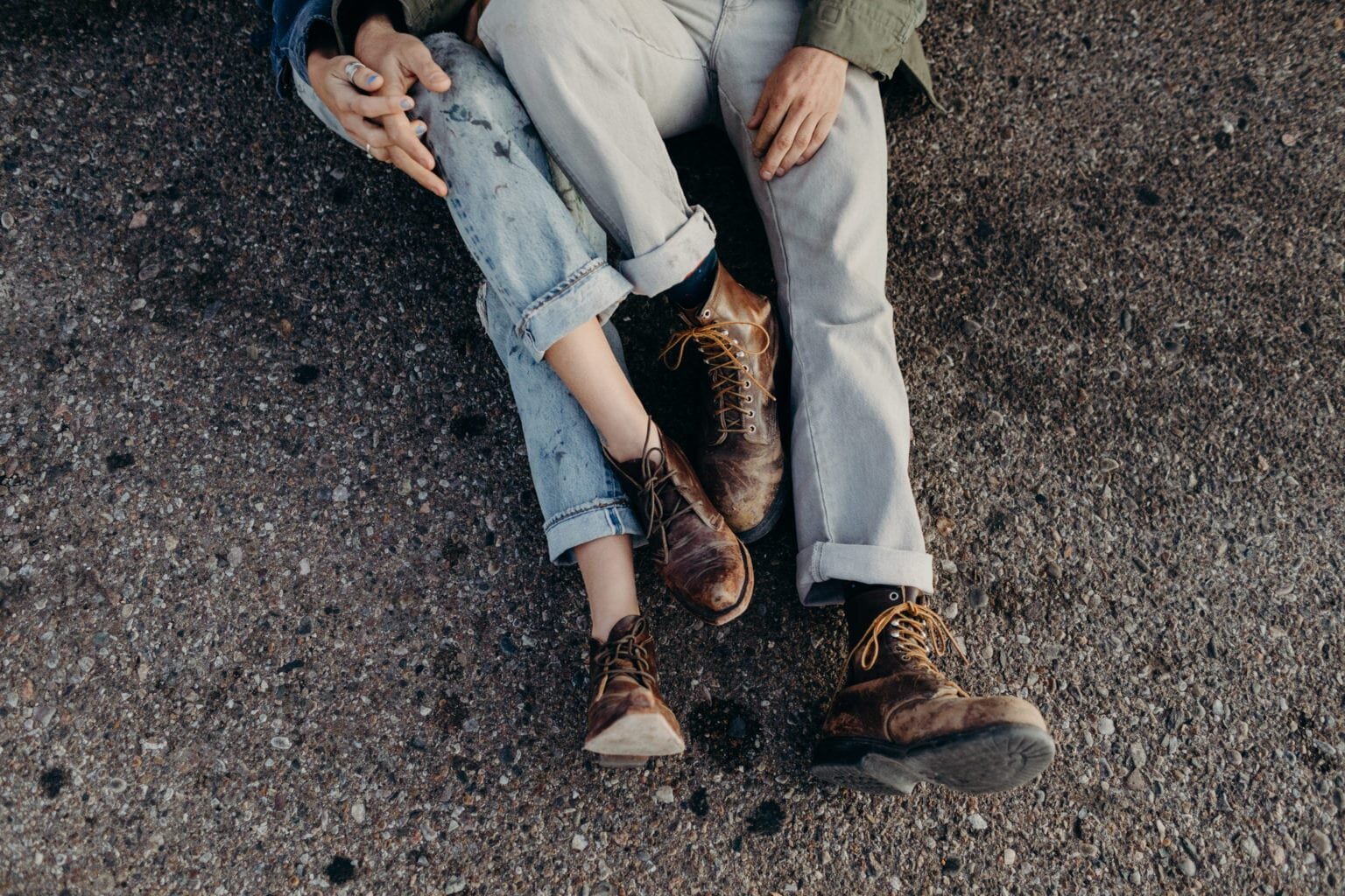 Couple under a car being cozy