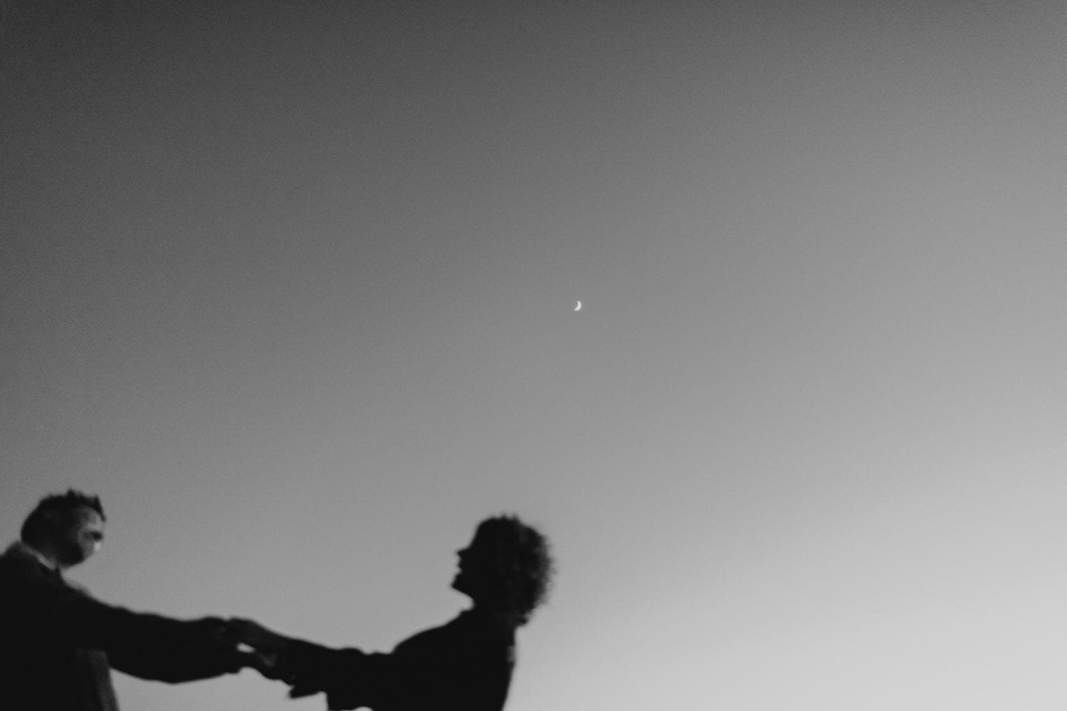Moon in the background of couple dancing