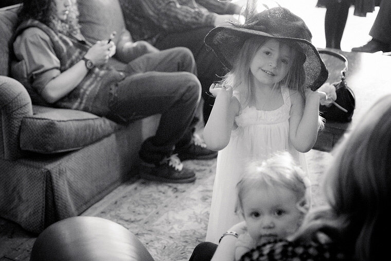 Little girl in a hat at a wedding.