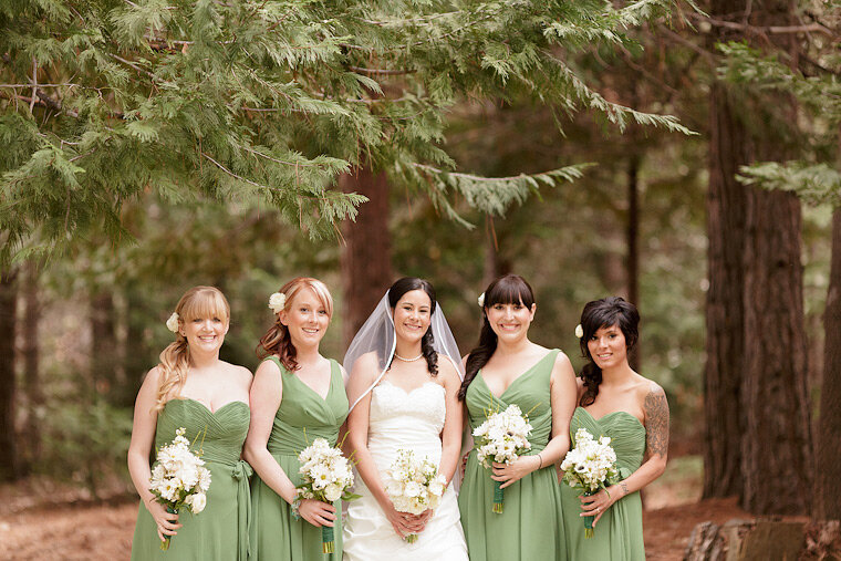 Formal portrait of bride and bridesmaids in the forest.